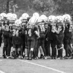 Youth football team in huddle