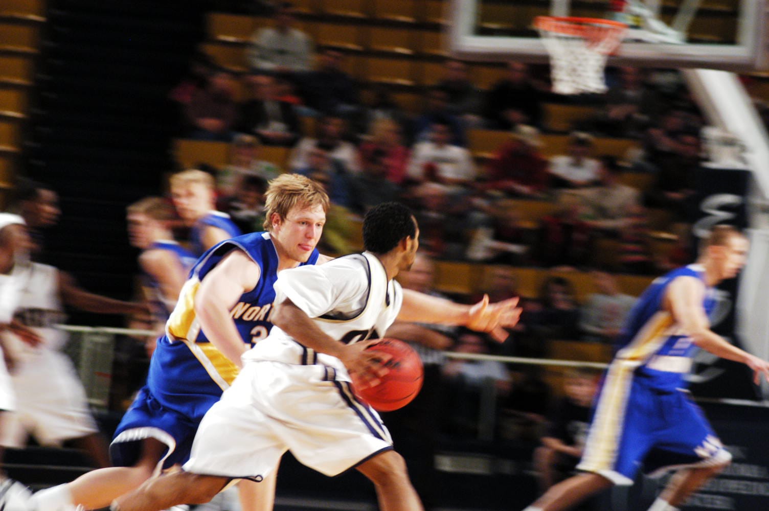 basketball player driving toward basket