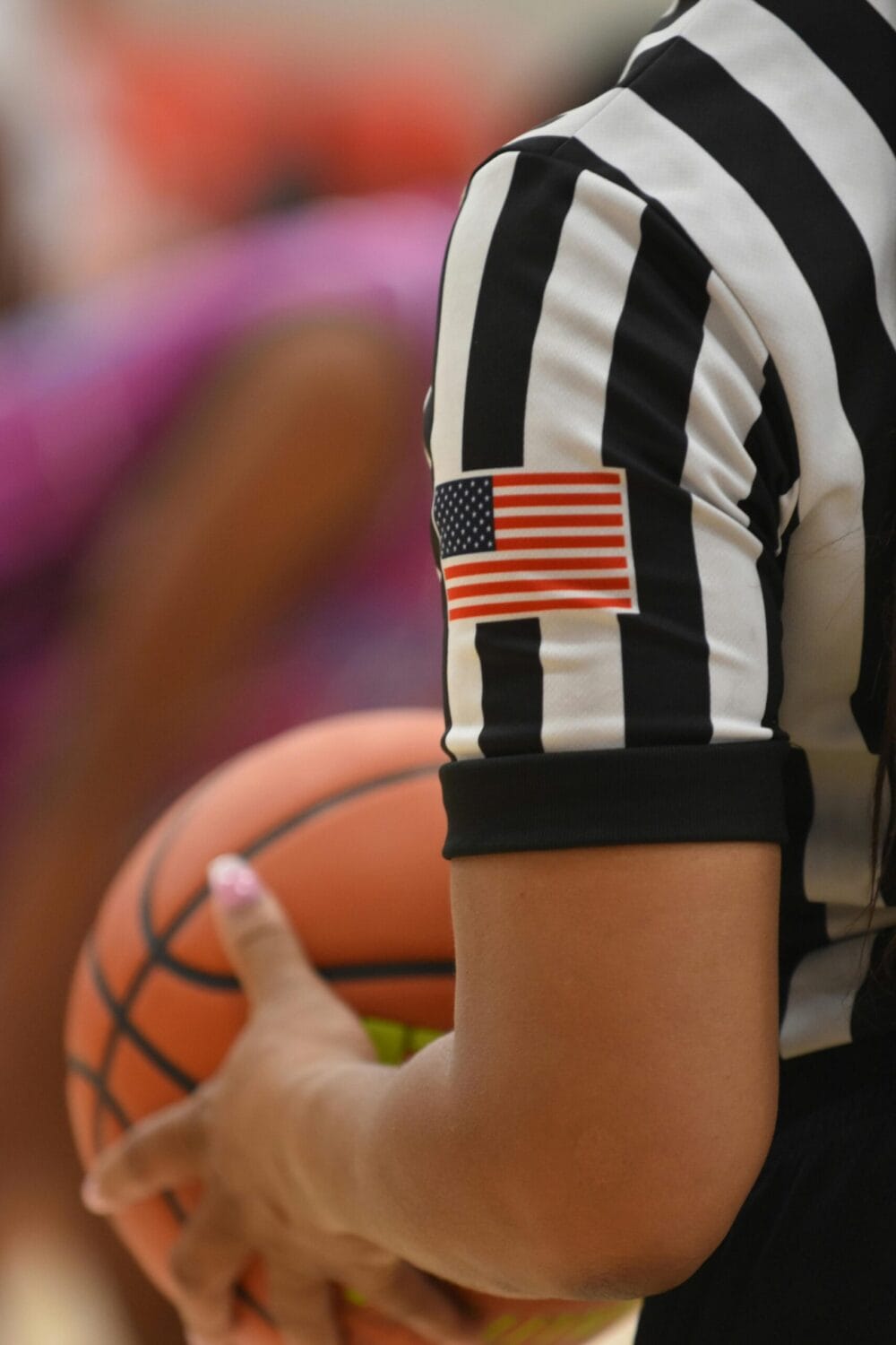 basketball referee holding a basketball