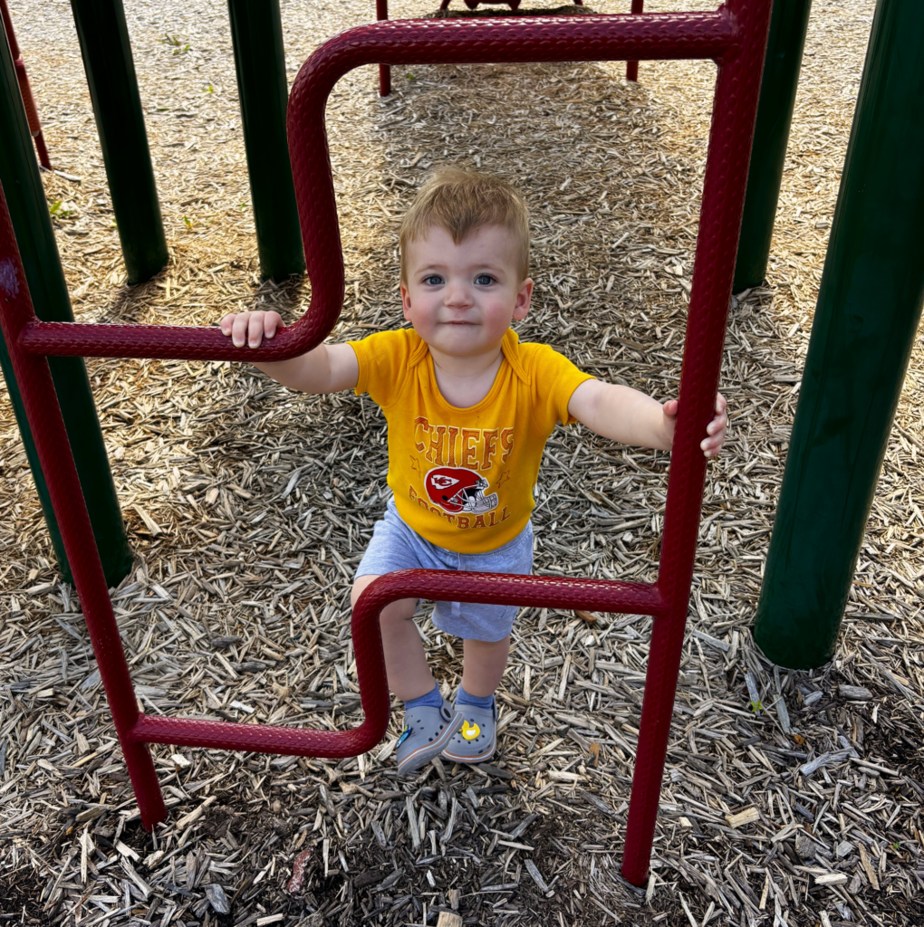 Toddler in Chiefs shirt on playground