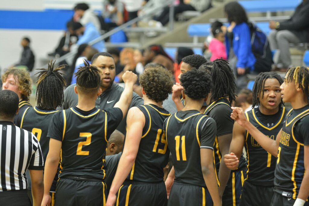 basketball team gathered around a coach on the basketball court