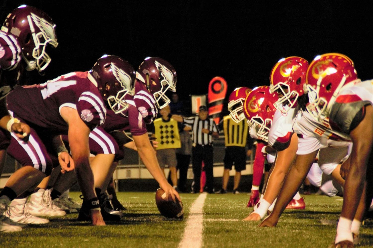 Closeup of football players down the line of scrimmage