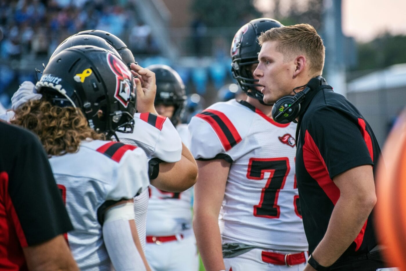 tim-mossholder-LMlylQhsLX8-unsplash - Ball to Life Sports group of football players with coach