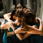 women athletes in a huddle