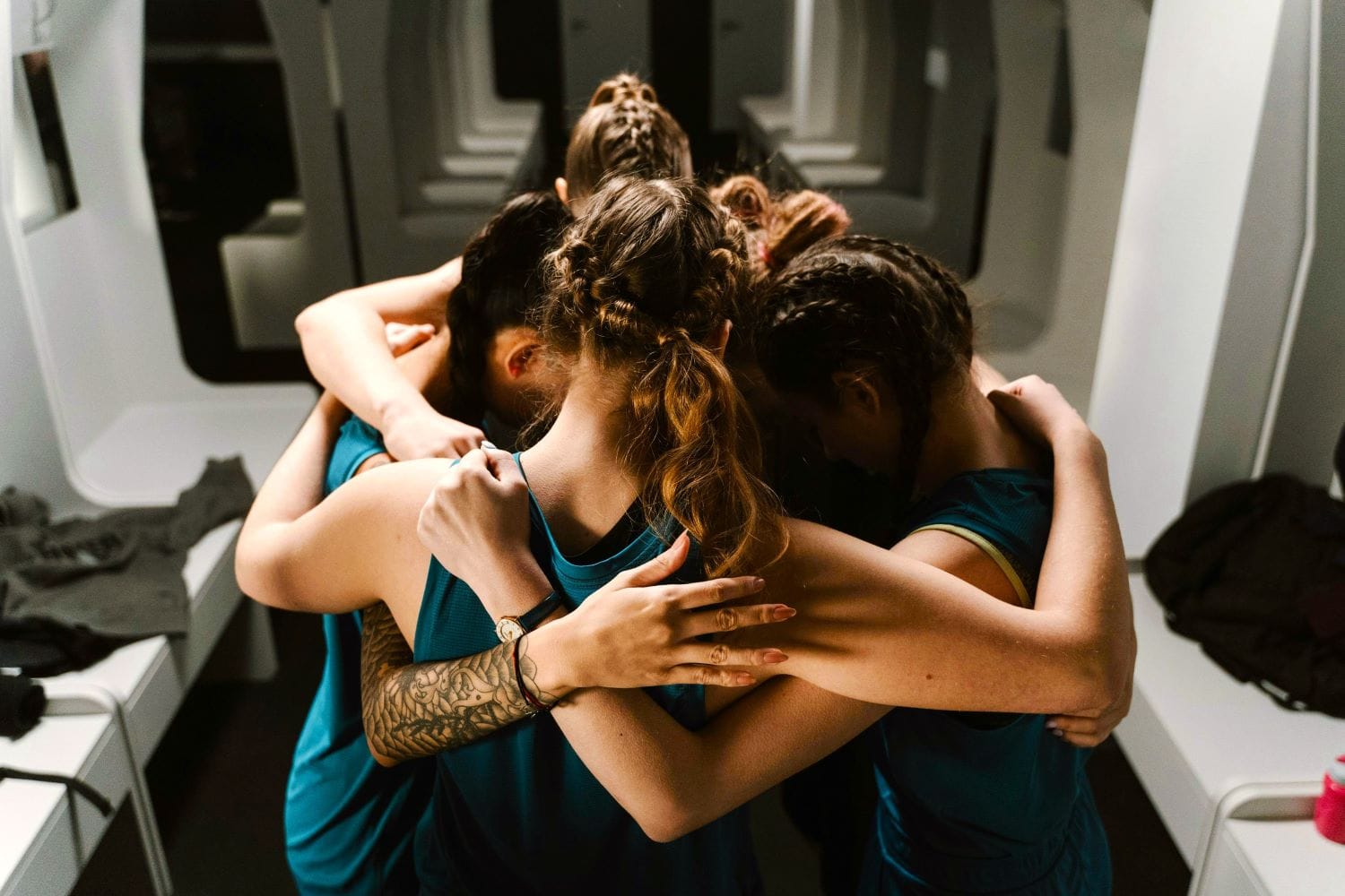 women athletes in a huddle