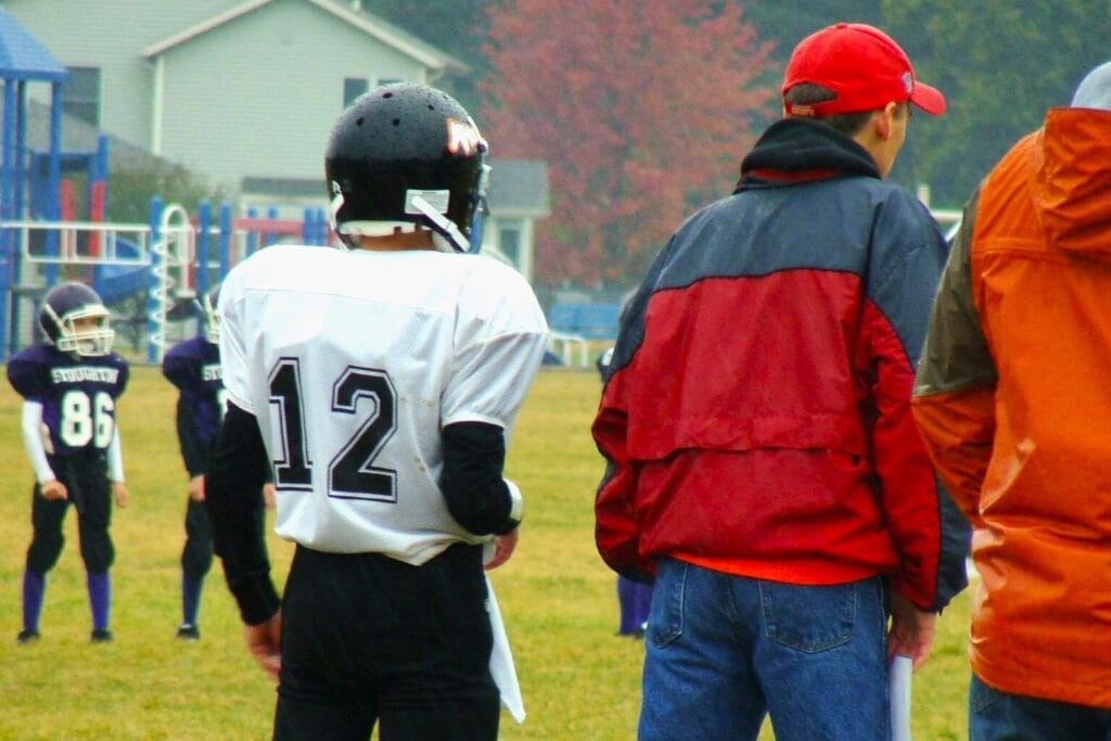 player and coach on sidelines