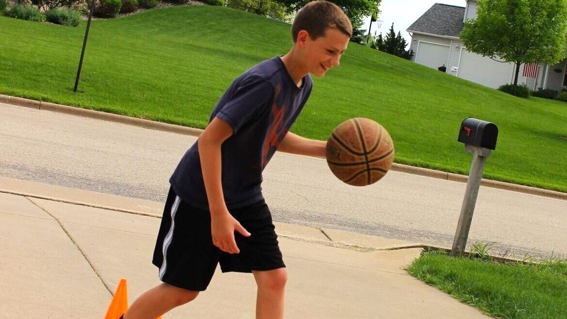 boy working on basketball drills