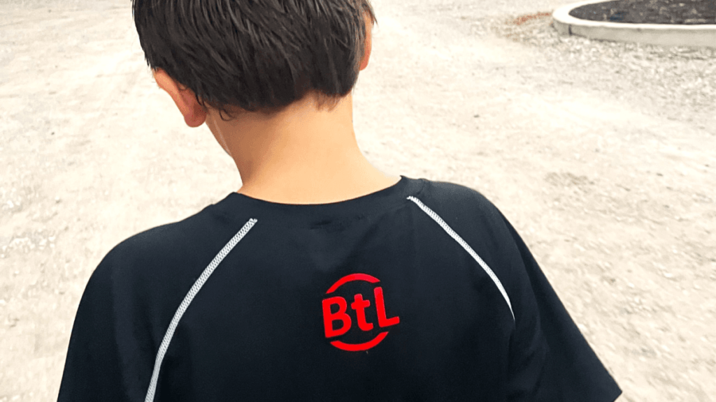 Jackson 2 071324 - Ball to Life Sports boy in ball to life shirt walking to football practice
