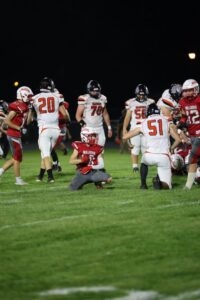 football player on knee holding football