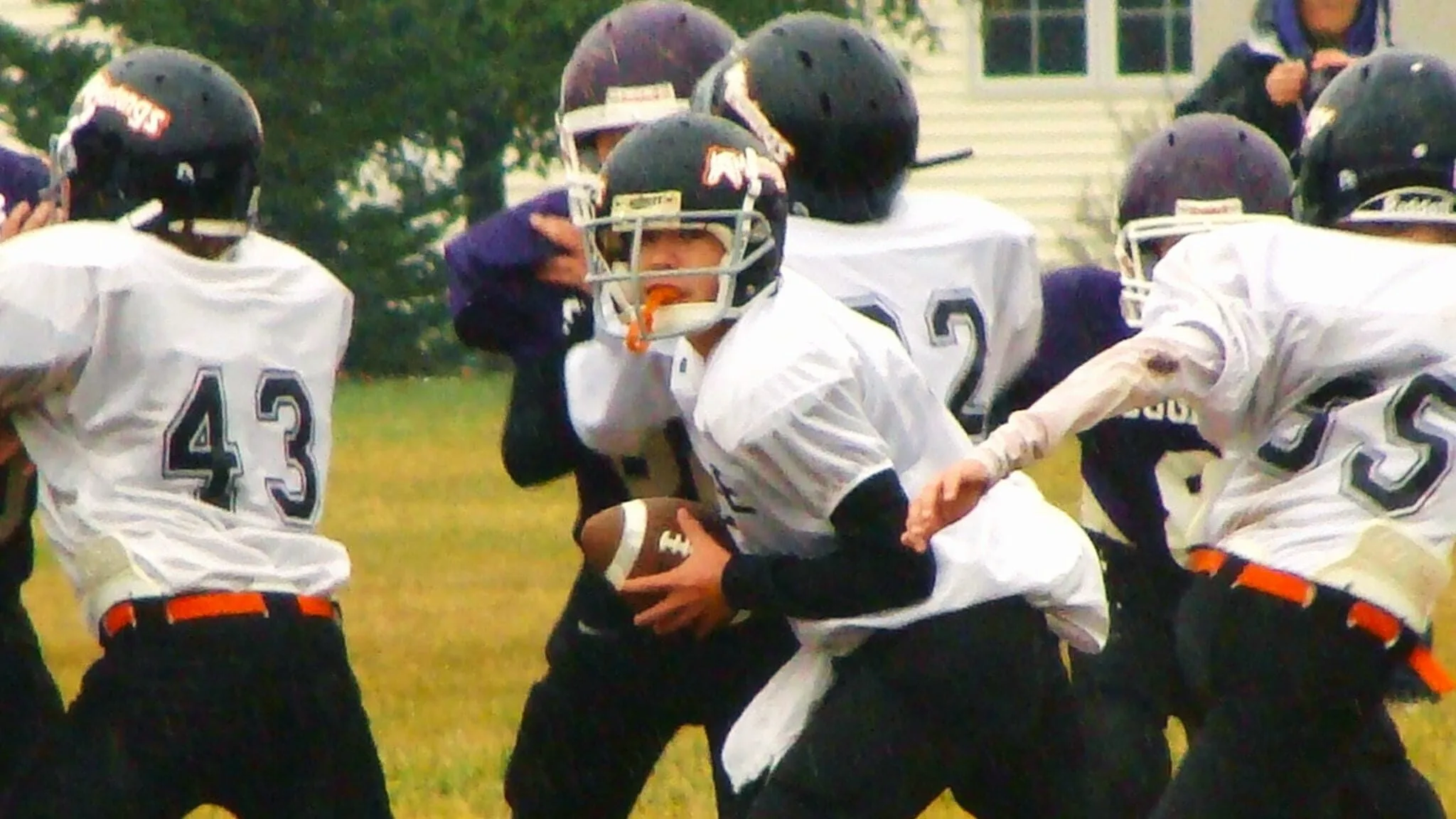 football after the snap - Ball to Life Sports quarterback taking the snap football