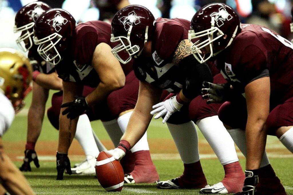 pexels-pixabay-163398 - Ball to Life Sports offensive lineman in stance waiting for ball to be snapped