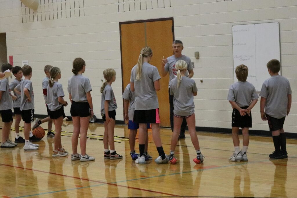 Coach Howard Blalock speaking at a camp
