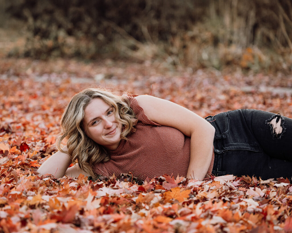 Trinity Baker Player Spotlight posing in leaves