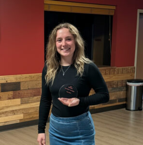 Player spotlight award winner posing with trophy