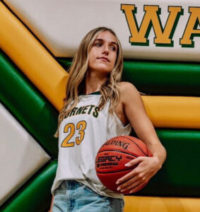 Isabella Bunders Closeup girl holding basketball leaning against wall